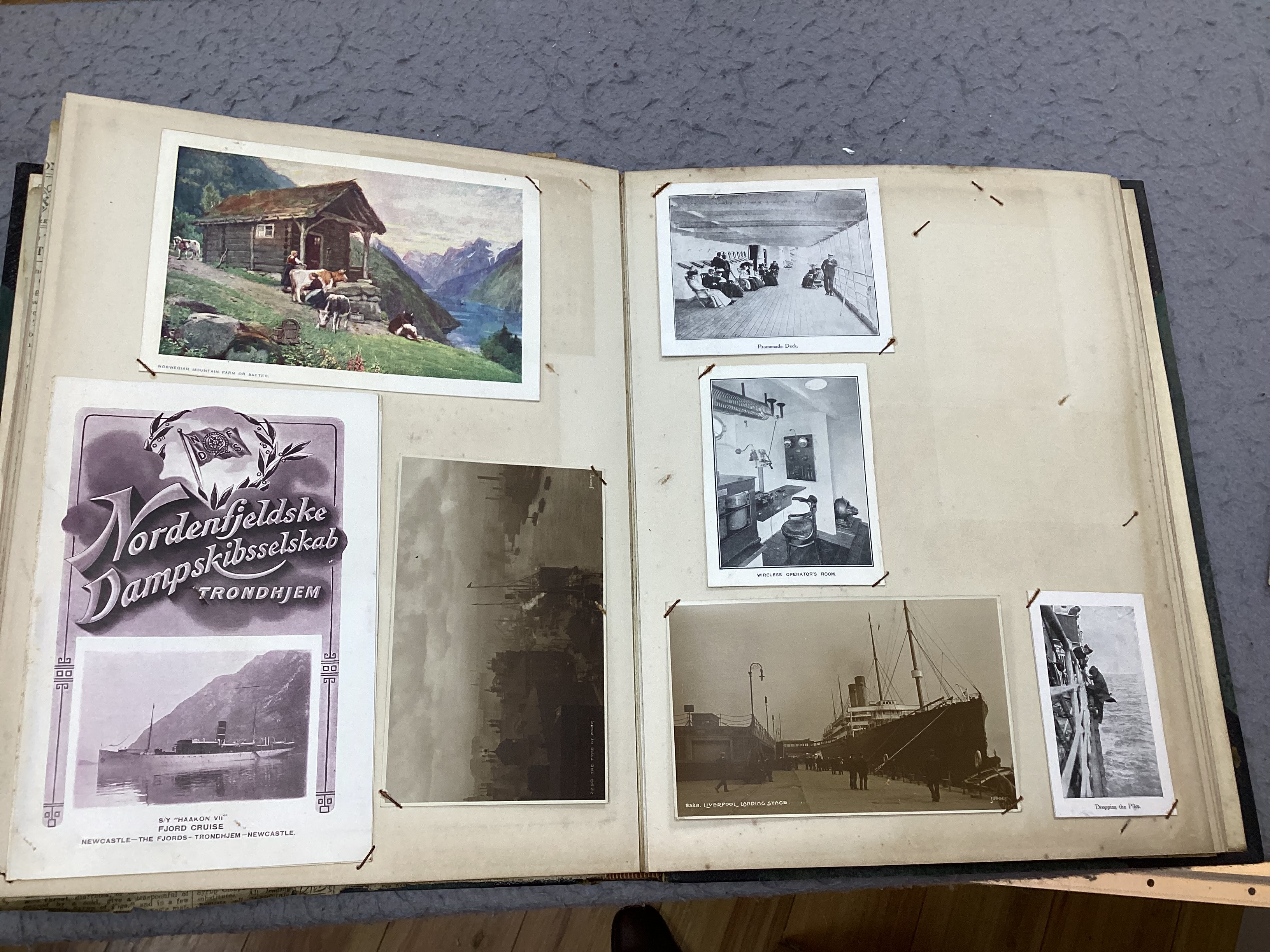 An Ocean liner scrap book and a collection of loose leaves of boating and shipping related postcards